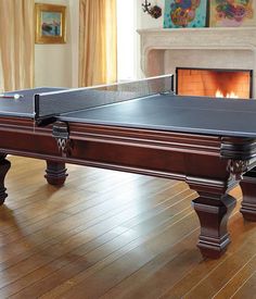 a ping pong table in front of a fireplace