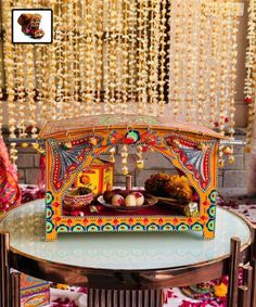 an elaborately decorated table with beads hanging from the ceiling