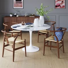 a white table with four chairs around it