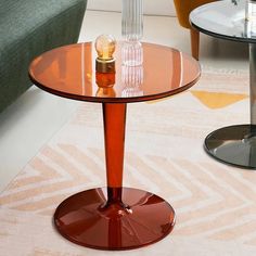 a glass table sitting on top of a carpeted floor