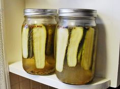 several jars filled with pickles sitting on top of a table