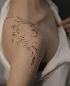 a woman with a tattoo on her shoulder