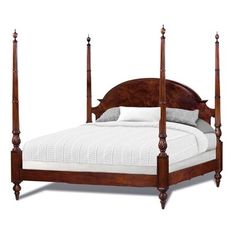 a wooden bed with four posts and white linens on the bottom, against a white background