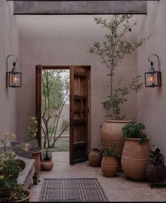 an instagram page with pots and plants on the front porch, in spanish style