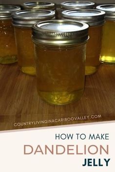 jars filled with honey sitting on top of a wooden table