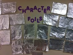 a bulletin board covered in lots of different types of paper and foil wrap around it