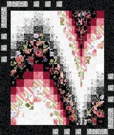 a black and white quilt with pink flowers on it