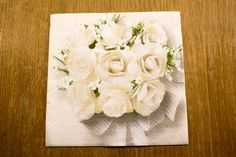 a napkin with flowers on it sitting on a table