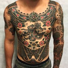 an image of a man with tattoos on his chest and chest, showing the back