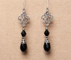 These elegant earrings are made from crystal beads and antique silver filigree. Available in black, red and amethyst. They will make a beautiful accessory for someone who loves Victorian or vintage style accessories. -Made from teardrop and bicone shaped beads, attached to rnate antique silver filigree -The earrings are 2 inches long, without the lever back closure -They have a lever back closure -Available in 3 colors: Black, Amethyst and Red, please select your preferred color from the drop do Gothic Earrings Victorian, Long Dangly Earrings, Elegant Beaded Earrings, 1800s Earrings, Cruise Jewelry, Crystal Bead Earrings, Handmade Earings, Gothic Jewelry Diy, Black Dangle Earrings