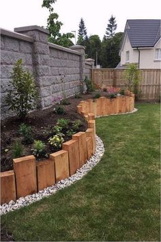 a garden with grass, rocks and plants in it