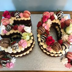 a number shaped cake sitting on top of a table covered in frosting and flowers