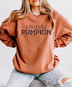 Howdy Pumpkin sweatshirt See the t-shirt here: https://thistleandmain.etsy.com/listing/1779232370 Comfort Colors 1466 sweatshirt is made with soft, ring-spun cotton fabric with 100% cotton threads, it sits unmatched when it comes to softness. All sweatshirts feature a rolled forward shoulder and are printed with OEKO-TEX-certified low-impact dyes. Lastly, Comfort Colors is a proud member of the US Cotton Trust Protocol which means sustainable cotton sourcing that's good for the environment.  -100% ring-spun cotton -Light fabric (6.4 oz/yd² (217 g/m -Relaxed fit -Sewn-in twill label Howdy Pumpkin, Farm Fresh Pumpkins, Comfort Colors Sweatshirt, Burnt Orange Color, Laid Back Style, Farm Fresh, Seasonal Fashion, Fall Wardrobe, Cotton Lights