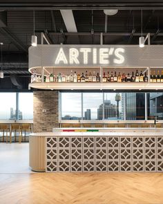 an empty bar with lots of bottles on it