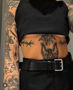 a woman with tattoos on her stomach and arms