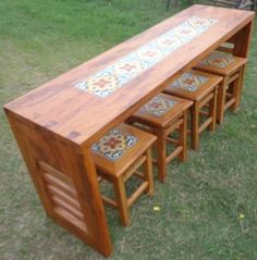 a wooden bench sitting on top of a grass covered field next to a park filled with benches