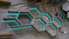 a room that has some lights on the walls and floors in it, with hexagonal