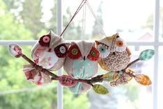 an owl mobile hanging from a window sill