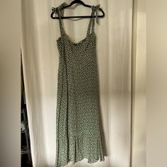 This Stunning Reformation Dress Features A Charming Green Floral Print With Adjustable Tie Straps For A Customizable Fit. The Smocked Back Provides Comfort While Maintaining A Flattering Silhouette. With A Flowy Skirt And A Flirty Hemline, This Dress Is Perfect For Any Occasion. Size: 12 Condition: Excellent, Lightly Worn. Green Floral Midi Dress, Reformation Dress, Green Floral Print, Reformation Dresses, Flowy Skirt, Floral Midi Dress, Floral Print, Size 12, Floral Prints