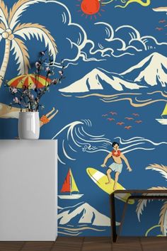 a room with a surfboard and palm trees on the wall next to a table