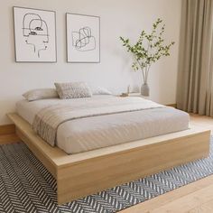 a large bed sitting on top of a wooden platform in a bedroom next to a window