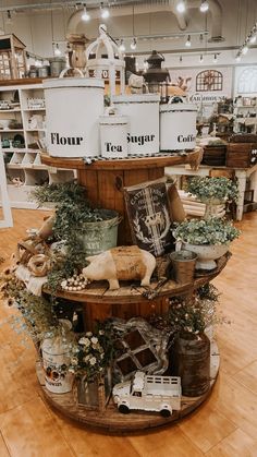 flour, tea, sugar, coffee canisters, greenery Farmhouse Store Design, Retail Set Up Display Ideas, Rustic Craft Booth Displays, Antique Vendor Booth Ideas, Furniture Vendor Booth Display, General Store Display Ideas, Farmhouse Store Display Ideas, Thrift Store Window Display Ideas, Spool Display Ideas