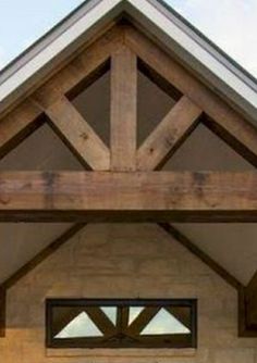 the front entrance to a home with an open door and two windows on each side