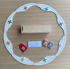 a toy train set on a table with business cards and magnets attached to the track