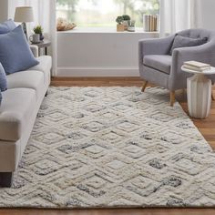 a living room with two chairs and a rug