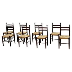 set of six chairs with woven seat cushions on each one side and four in the back