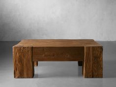 a wooden table sitting on top of a cement floor