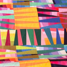 an abstract quilt made with multicolored strips