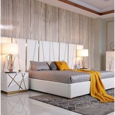 a bedroom with a bed, nightstands and lamps