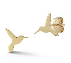 a pair of gold hummingbird earrings on a white background with the word love written in it