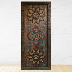 an ornate wooden door with floral designs on it