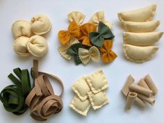 several different types of felt flowers on a white surface