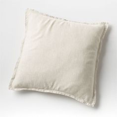 a white pillow sitting on top of a white table