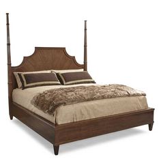 a bed with four posts and pillows on it's headboard is shown in this image