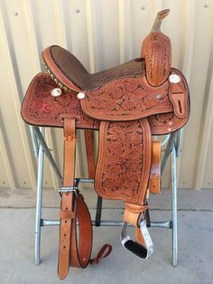 the saddle is ready to be used as a horse tacking station for horses and their riders