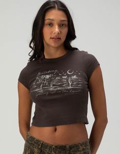 Billabong Lost Desert Baby Tee. Large Graphic Screened On Front. Ribbed Crew Neckline. Short Sleeve. Shrunken Fit. 100% Cotton. Machine Wash. Imported. Model Is Wearing A Size Small. Model Measurements:height: 5'8" Bust: 32"waist: 24"hips: 35" Cheap Gap T-shirt With Screen Print, Billabong Graphic Tees, Graphic Print Relaxed Fit Crop Top, Grunge Lifestyle, Hippie Baby, Graphic Baby Tee, Boho Tees, Baby Graphic Tees, Cute Graphic Tees