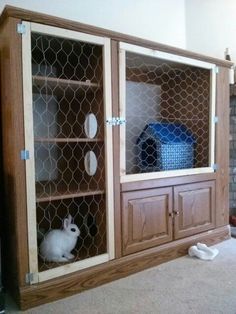 a wooden cabinet with chicken wire on the doors