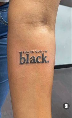 a person with a tattoo on their arm that says, thank god i'm black