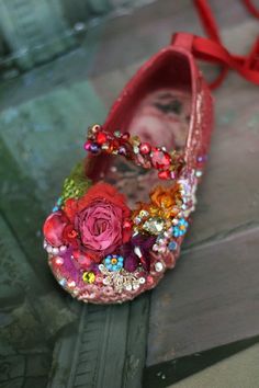 a close up of a pair of shoes with flowers on them