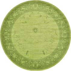 a green rug with an oval design in the middle