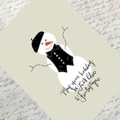 a snowman wearing a black hat and scarf with the words merry christmas written on it