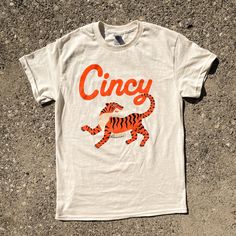 Show your Cincinnati sportsball pride with our Cincy Tiger shirt. This 100% cotton T-shirt looks like a faded white vintage tee, or the best vanilla bean ice cream!  * printed on a unisex 100% cotton T-shirt * fits true to size; if in-between sizes, we suggest sizing up * screen printed locally in Cincinnati Bean Ice Cream, Tiger Shirt, Vanilla Bean Ice Cream, Bengal Tiger, Tiger T Shirt, Shirt Fits, Vintage Tee, Vanilla Bean, Vintage Tees