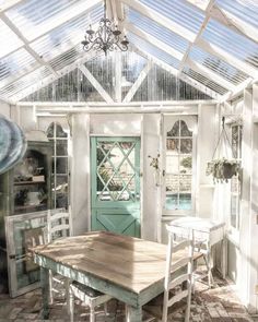 a table and chairs in a room with a glass roof over the pool side door