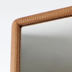 a close up of a mirror with a wooden frame and wood grain pattern on it