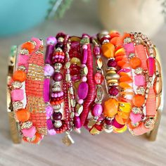 Part Of Our New Signature Stack Collection Of Artisan Beaded Stretch Boho Bracelet Sets. This Super-Sized Set Features Shades Of Coral, Pink, Magenta, Gold, Amber & Orange. Picture Witnessing A Stunning Sunset Seemingly Rising From The Sands Of The Sahara. There Are 14 Gorgeous Beaded Stretch Bracelets And 1 Seed Beaded Pull-To-Fit Tassel Back Bracelet For A Total Of 15 Pcs. The Gold-Dipped Charms Include Feathers, Cactus, Crescent Moon & Geometric Shapes. All Items From Our Own Artisan Line Of Multicolor Bohemian Beaded Bracelets For Festive Occasions, Multicolor Bohemian Beaded Bracelet For Festive Occasions, Bohemian Pink Hand Wrapped Friendship Bracelets, Pink Hand-strung Bohemian Friendship Bracelets, Hand-strung Pink Jewelry For Festivals, Pink Hand-strung Jewelry For Festival, Adjustable Pink Bohemian Beaded Bracelets, Pink Bohemian Beaded Bracelets For Festivals, Pink Hand Wrapped Friendship Bracelets For Festivals