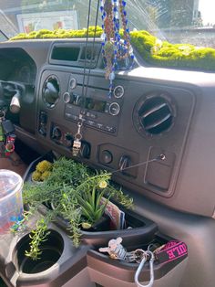 the interior of a car with plants and other items in it's dash board